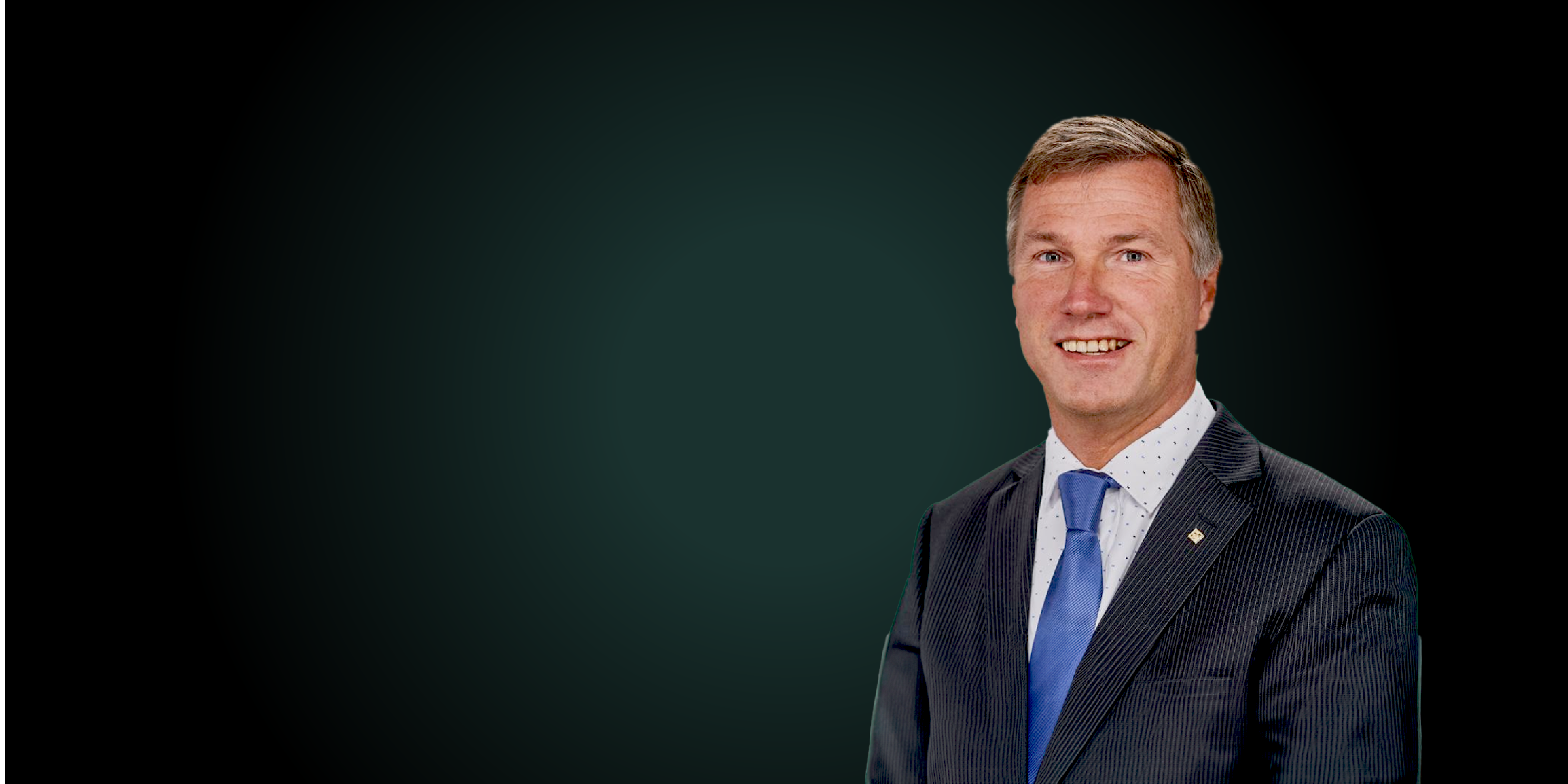 A smiling man dressed in suits